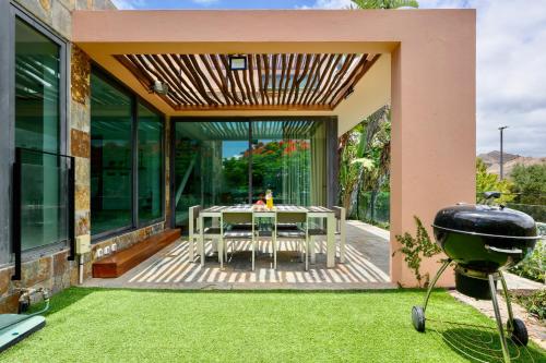 une terrasse avec une table et un grill dans une maison dans l'établissement Villa With Private Pool In Luxury Golf Resort, à Salobre