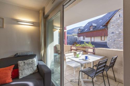 Cette chambre dispose d'une table, de chaises et d'un balcon. dans l'établissement Appt 4 pers tout équipé, hypercentre village, fibre, garage, linge fourni, à Saint-Lary-Soulan