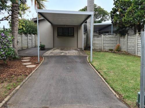 a driveway leading to a house with a garage at Acacia's Rest in Port Shepstone