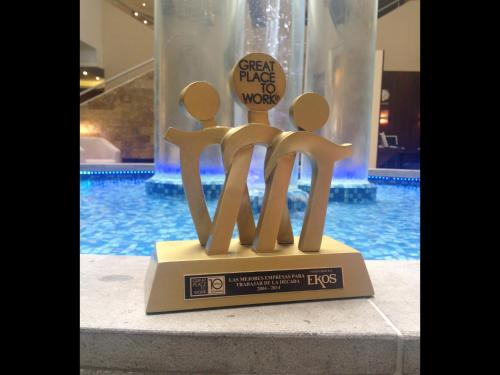 a figurine of people on a plaque in front of a pool at Mercure Alameda Quito in Quito