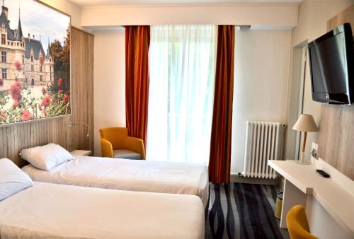 Un ou plusieurs lits dans un hébergement de l'établissement Kyriad Hotel Tours Centre