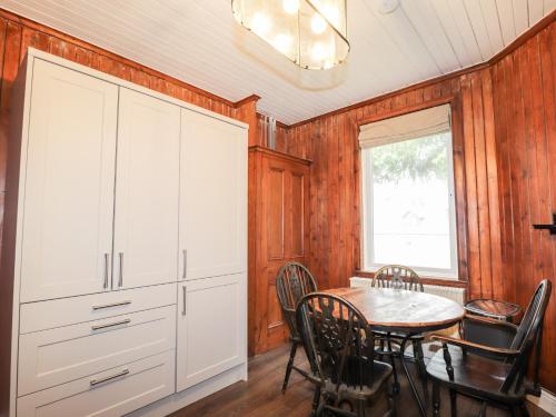 a dining room with a table and chairs at Challenger Bothy in Lairg