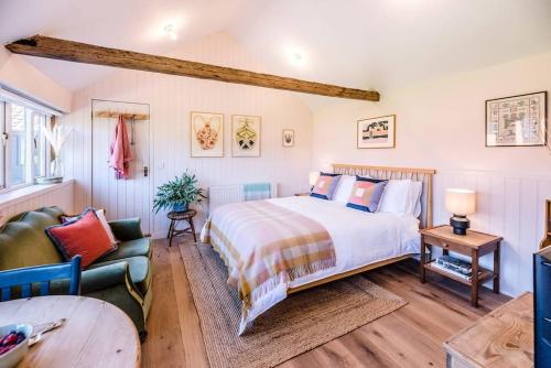 a bedroom with a large bed and a couch at The Studio, Hoo in Woodbridge