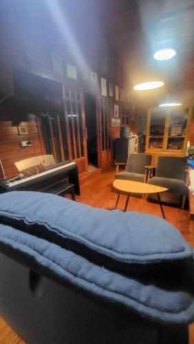 a room with a bed and a table and chairs at Aran Cottage Ngamwongwan The Pool Villa in japanese Garden in Nonthaburi