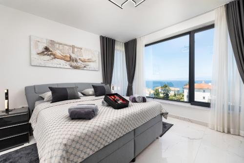 a bedroom with a bed and a large window at Apartment Magdalena in Malinska