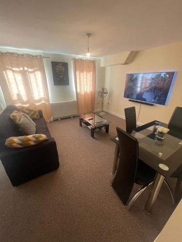 a living room with a couch and a table at TANGO APARTMENTs in London