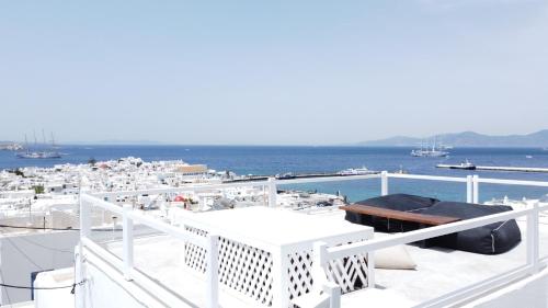 a white deck with a view of the ocean at Cloe Cycladic Residence, by Mykonos High in Mýkonos City
