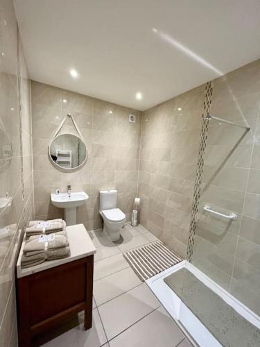 a bathroom with a shower and a toilet and a sink at One Bedroom Apartment in Bangor in Bangor