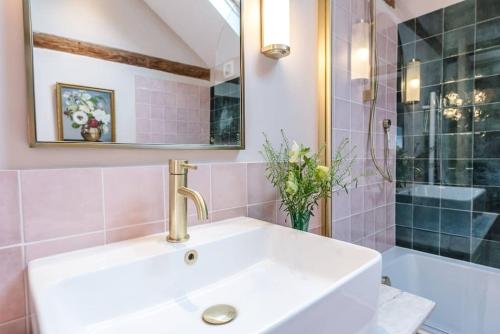 a bathroom with a sink and a shower at The Stables, Hoo in Woodbridge