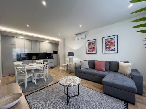 a living room with a couch and a table at Alta Lisboa Apartment in Lisbon