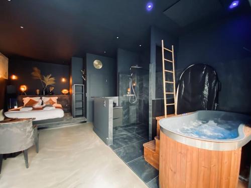 a bathroom with a tub and a bed and a ladder at La Shelby avec terrasse privée in Bordeaux