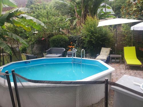 a hot tub in a yard with a patio at Chez Bouju in Castetnau-Camblong