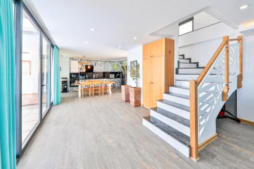 a living room with stairs and a dining room at Villa Jilda Kalkan in Kalkan