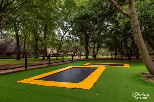 a basketball court in a park with green grass at Kruger Park Lodge Unit No 252 with private pool in Hazyview