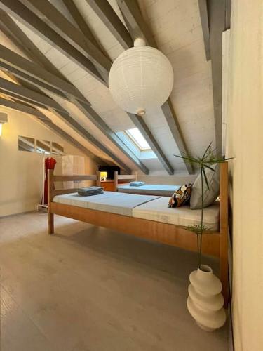 a large room with a large bed in a attic at Apartman Ezza in Lopud