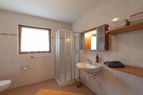a bathroom with a sink and a shower and a toilet at Mesnerhof my Paradise in Fiè