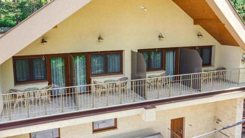 a balcony of a house with chairs and windows at Josephus Vendégház in Kötcse