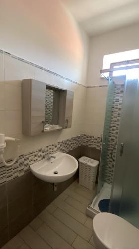 a bathroom with a sink and a toilet and a shower at Anema e Core Pizzo in Pizzo