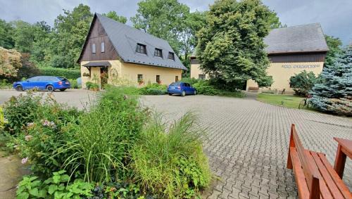 a house with two cars parked in front of it at Na Statku Babiččino údolí in Česká Skalice