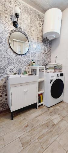 a kitchen with a sink and a washing machine at Apartments TERRAeSAL in Zadar