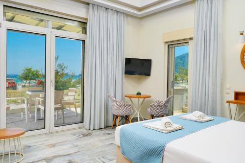 a hotel room with a bed and a balcony at Vereya Beach in Chrysi Ammoudia