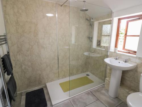 a bathroom with a shower and a sink at Avoine Cottage in Gloucester