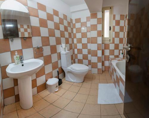a bathroom with a sink and a toilet and a tub at Private room in shared flat in Nicosia