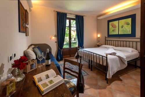 a bedroom with a bed and a table in a room at Agriturismo Cascina Monchiero in Bra