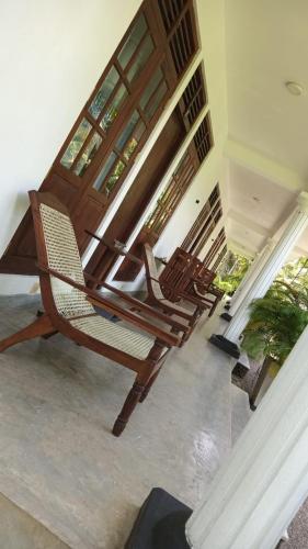 a set of stairs in a house with a chair at New Holiday Reach in Unawatuna