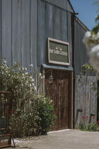 a building with a sign that reads they built garden at Outbuildings Dorset in Bridport