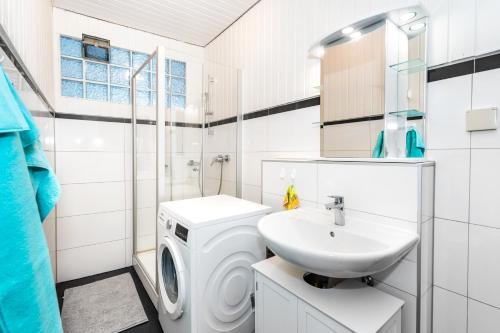 een badkamer met een wasmachine en een wastafel bij Ferienwohnung historischer Markt in Heppenheim an der Bergstrasse