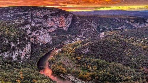 an aerial view of a canyon with a river at Villa Les Romarins in Vallon-Pont-dʼArc