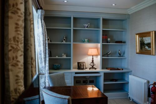 a room with a desk and a lamp on a shelf at Links House at Royal Dornoch in Dornoch