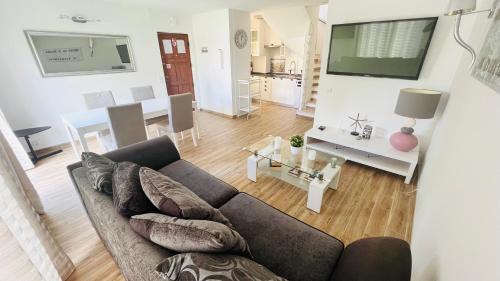 a living room with a couch and a table at Charming triplex T2 in the Old Village Vilamoura in Quarteira