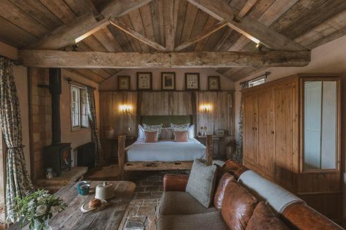 a living room with a bed and a couch at Outbuildings Dorset in Bridport