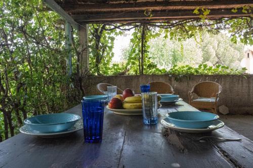 una mesa de madera con un plato de fruta. en DomoMea - CàFè en Geremèas