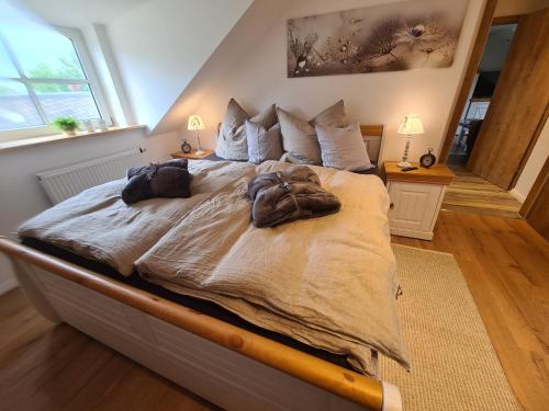 a bedroom with a large bed with two bags on it at Rosenzauber Gipfelstürmer in Weißenstadt