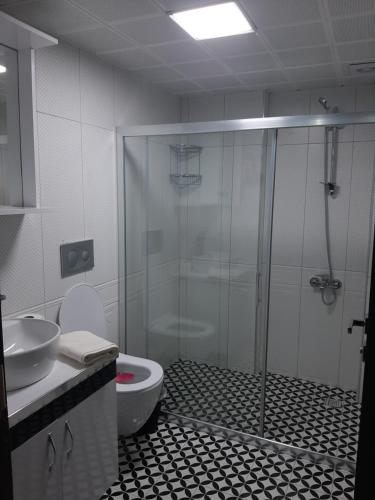 a bathroom with a shower and a toilet and a sink at Unuvar home in Kusadası