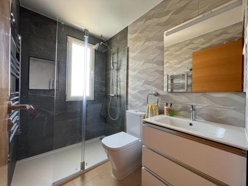 a bathroom with a shower and a toilet and a sink at Villa Sam in Murcia