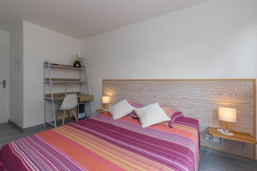a bedroom with a large bed with two pillows at Etchetao in Boucau