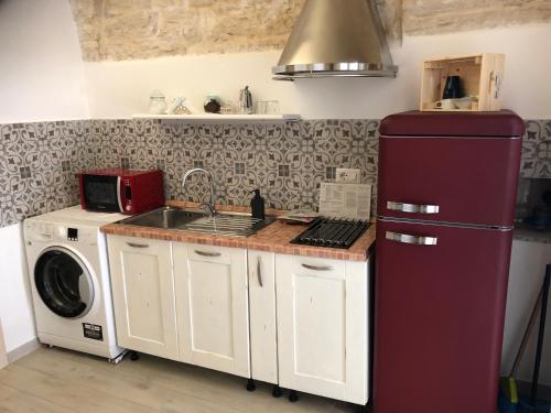 a kitchen with a refrigerator and a washing machine at La piccola casa di Tania in via Fiore in Terlizzi