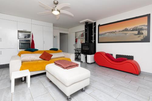 a bedroom with a bed and a chair and a television at Etchetao in Boucau