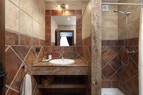 a bathroom with a sink and a mirror at Pasa Fina, luxury holiday retreat in Villanueva del Trabuco