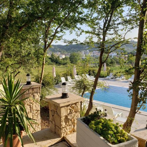 a view of a resort with a pool and trees at Green Hill Apartments in Ulcinj