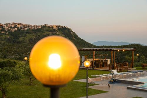a large yellow egg on a pole next to a pool at L' Aia Resort in Trentinara