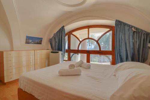 a bedroom with a bed with two towels on it at "Le Winter Palace" Prestigieux, Centre, Calme in Menton