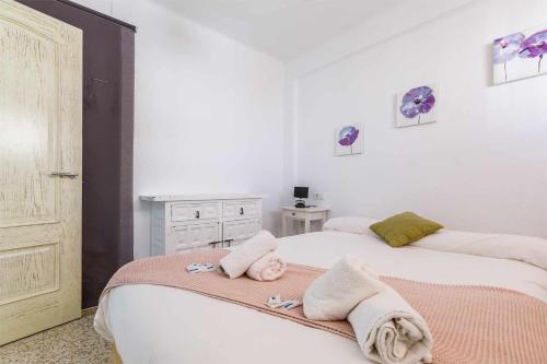a bedroom with two beds with towels on them at A&N Nevada 76 in Torre del Mar