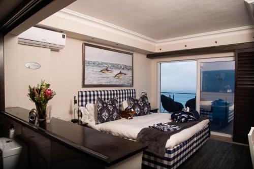 a bedroom with a bed and a large window at Head over Hills in Knysna