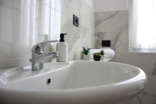 a bathroom sink with a soap dispenser on it at [Stazione] - Casa privata con veranda in Romano di Lombardia
