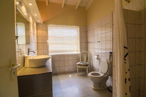 La salle de bains est pourvue d'un lavabo, de toilettes et d'une baignoire. dans l'établissement 28 Casa Ruby, à Kralendijk